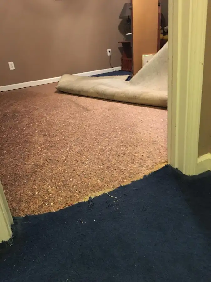 Carpet pad removal revealing water damage during Water Mitigation Services in Bluffdale